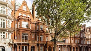 A row of Victorian-style brick buildings with large windows and ornate detailing.