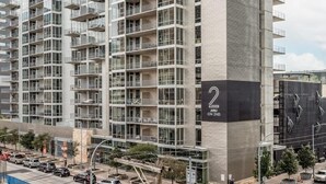 A modern high-rise building with multiple balconies and large windows. - Austin Modern 1BD 1BA 2nd Street District Apartment (Austin)