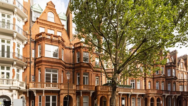 A row of Victorian-style brick buildings with large windows and ornate detailing. - The Knightsbridge Suite Next to Sloane Square (London)