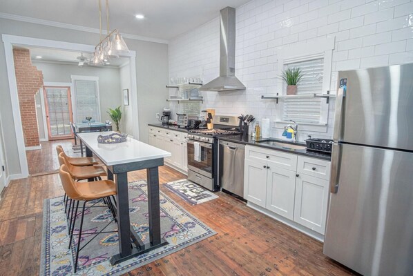 Enjoy cooking in the fully equipped kitchen with a large stove, oven, and refrigerator.