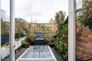 Enjoy the serene view of the surrounding urban environment from this tranquil garden oasis.