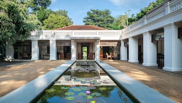 Experience the serene ambiance of our tranquil courtyard, surrounded by elegant columns and a peaceful water feature.
