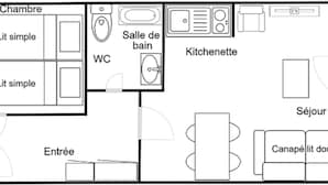 A floor plan of a hotel with a simple room layout, a WC, a kitchenette, a balcony, and a seating area.
