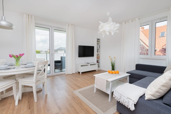 The living room's modern furnishings create a welcoming atmosphere.