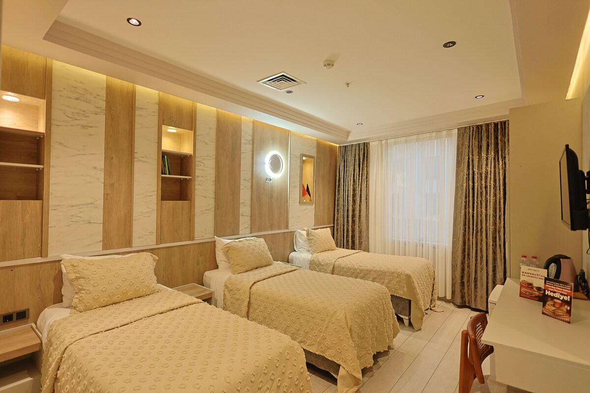 Deluxe Triple Room, City View | Minibar, desk, laptop workspace, soundproofing