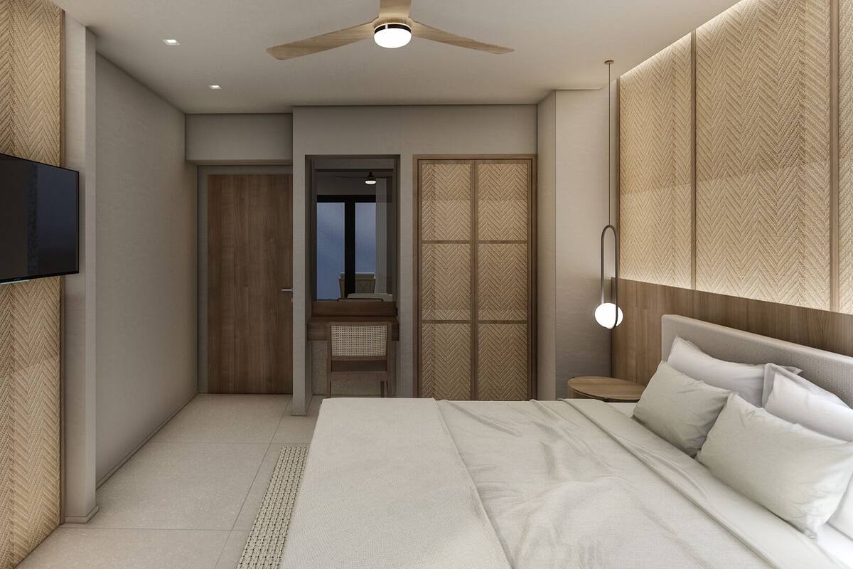 A modern bedroom with a bed, a TV mounted on the wall, a ceiling fan, and a view through a door.