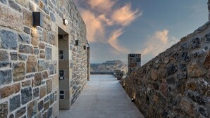 A stone corridor with a view of distant mountains and a cloudy sky. - Unique view (Rethymno)