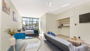 Comfort Apartment | Living area | 50-inch flat-screen TV with cable channels, TV, streaming services