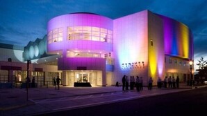 A modern building with a curved facade and large windows.