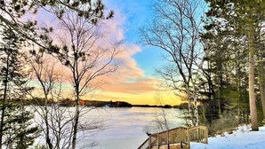 A wooden bridge over a frozen lake surrounded by trees. - Long Lake Retreat in Phillips, Wisconsin (Phillips)