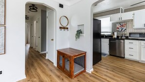 A modern kitchen with white cabinets, a stainless steel refrigerator, and a microwave. - Parma Home w/ Hot Tub and Arcade Room! (Parma)