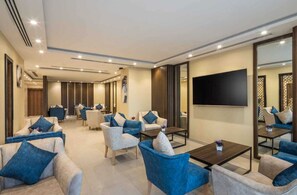 Deluxe Room | Living area | Flat-screen TV, video-game console, iPod dock, smart speakers