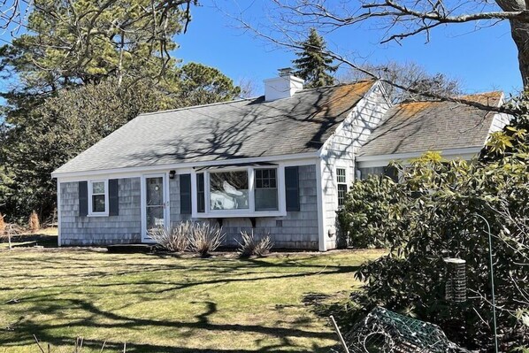 A small, single-story house with a gabled roof and a front porch.