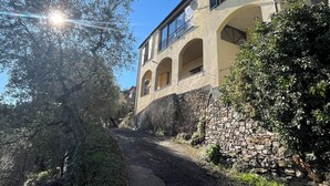 A building with arched windows and a stone wall. - Casa Norvegia by Interhome (Valloria)