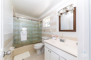 Bathtub, towels, soap, toilet paper