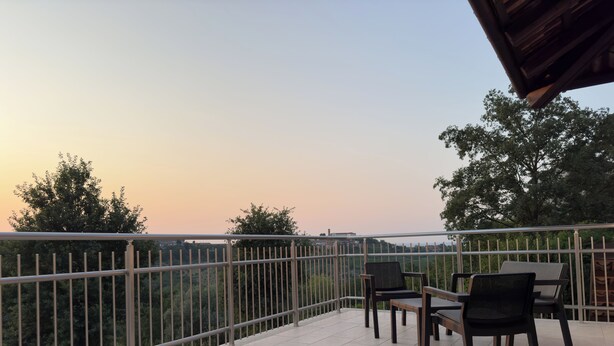 A balcony with tiled flooring, metal railing, and two chairs. - 4 Bedroom Private vacation home in Govone (Govone)