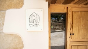 A wooden door with a sign above it that reads "PAORRA BASERRIA". - Paorra Baserria (Aia)