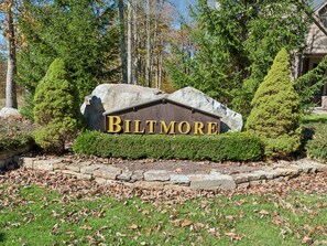 A sign with the word 'BILTMORE' on a rock, surrounded by trees and a stone pathway. - John's Place by Taylor Made Deep Creek (McHenry)