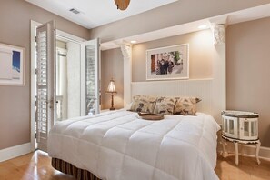 A bedroom with a large bed, a side table, a lamp, and a framed picture on the wall. - 8 Mizzenmast Court at The Sea Pines Resort (Hilton Head Island)