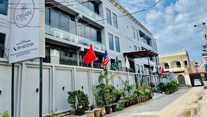 A modern hotel building with a sign for OBAN HOTEL, located on Bosan Road near the Business City Plaza. - Oban Hotel Multan- Managed by GOHO (Multan)