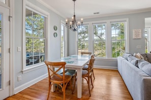 Enjoy meals in this dining area with a table for four, surrounded by comfortable chairs and a sofa.