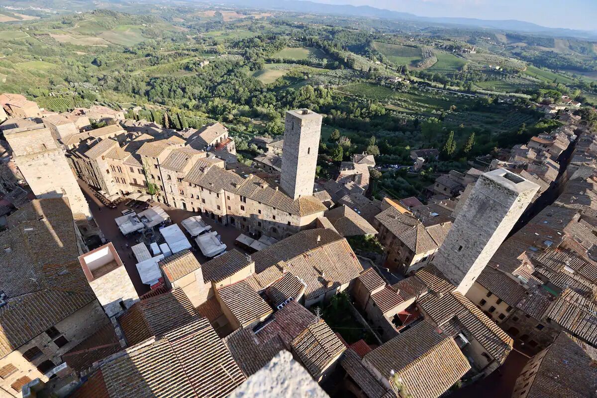 A historic town with medieval architecture, including a prominent tower and narrow streets.