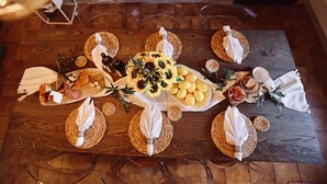 A wooden table set with various food items, including cheese, bread, and lemons, arranged on woven placemats. - Welcome "Casa San Gimi" your perfect base for exploring the wonders of Tuscany!  (San Gimignano)
