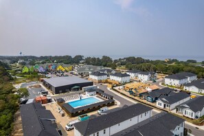 A residential area with houses, a swimming pool, and a large building labeled 'COSCO'. - The Lighthouse -Steps to Beach!  Luxury Amenities! (Corolla)