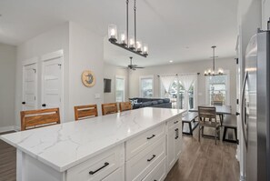 Spacious kitchen island overlooking the dining and living areas. - The Lighthouse -Steps to Beach!  Luxury Amenities! (Corolla)