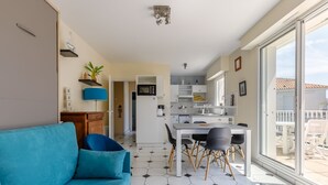 A modern apartment with a living room, kitchen, and balcony. - L'Hollywood Zen - One Bedroom Apartment, Sleeps 4 (Saint-Jean-de-Monts)