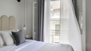 A bedroom with a bed, a nightstand, a lamp, and a window with curtains. - Beautiful Acropolis Villa 3BR 9ppl 10 minutes Metro&Museum (Athina)