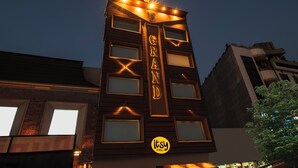 A hotel building with illuminated signage reading "GRAND" and a logo for "itsy Hotels by Treebo". - Itsy Hotels P Grand (Ludhiana)