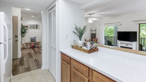 A kitchen with wooden cabinets, a countertop, and a television. - Spacious townhome within steps of Apple Valley Golf Course--Indoor pool! (lake lure)