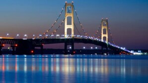 A bridge with two towers and a span decorated with lights.