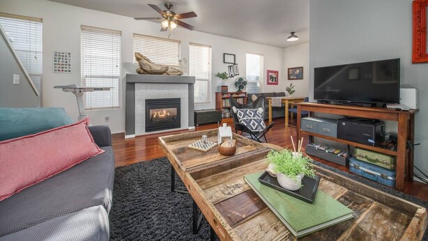 A living room with a fireplace, a television, and a bookshelf. - Book NOW for Summer Fun! - Perfect for family! - Fully Loaded! - Fire Pit! (Portland)