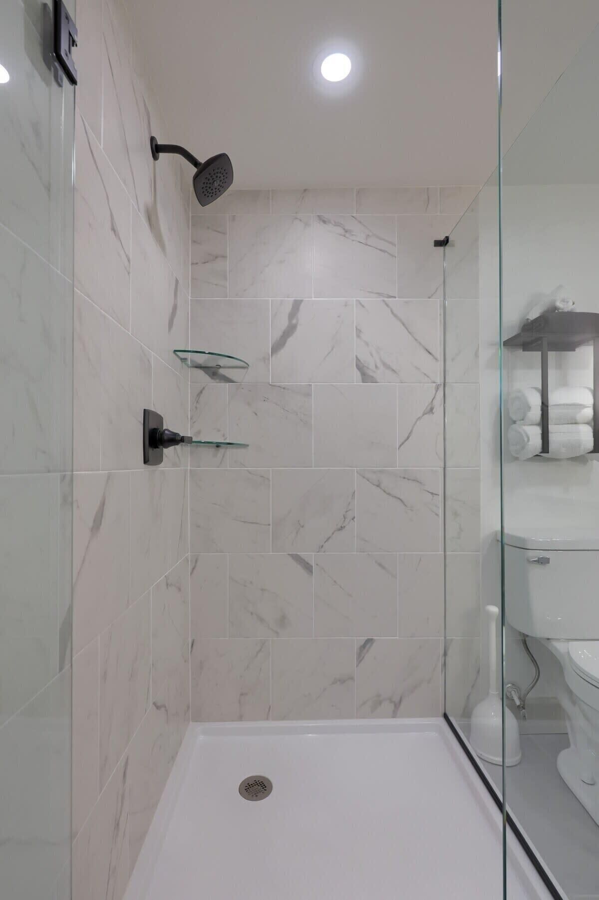 Shower, hair dryer, towels, shampoo