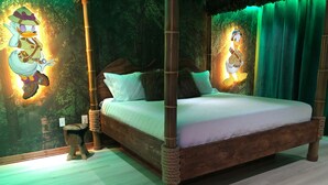 A four-poster bed with a wooden frame and a white mattress. The room has a forest-themed wall mural with two cartoon ducks. - Disney Dream House, Themed Rooms Pool Arcade BBQ! (Four Corners)