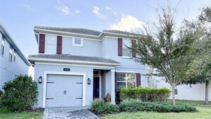 A two-story house with a garage, number 1612, and a paved driveway. - Disney Dream House, Themed Rooms Pool Arcade BBQ! (Four Corners)