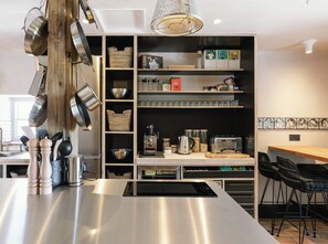 A modern kitchen with stainless steel appliances, a built-in oven, and a coffee station. - Stay Lagom Lodge (Ballycastle)