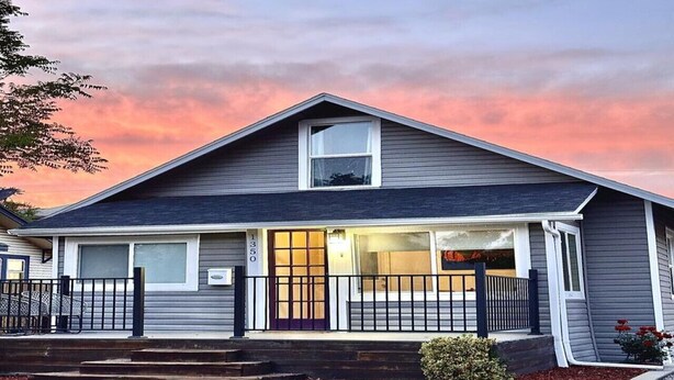 A two-story house with a gabled roof, a front porch, and a small front yard. - Artful Retreat Near GJs Main St: Dog-Friendly (Grand Junction)