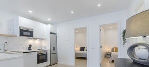 Enjoy a spacious open-plan kitchen, dining area, and living space in this stylish apartment.
