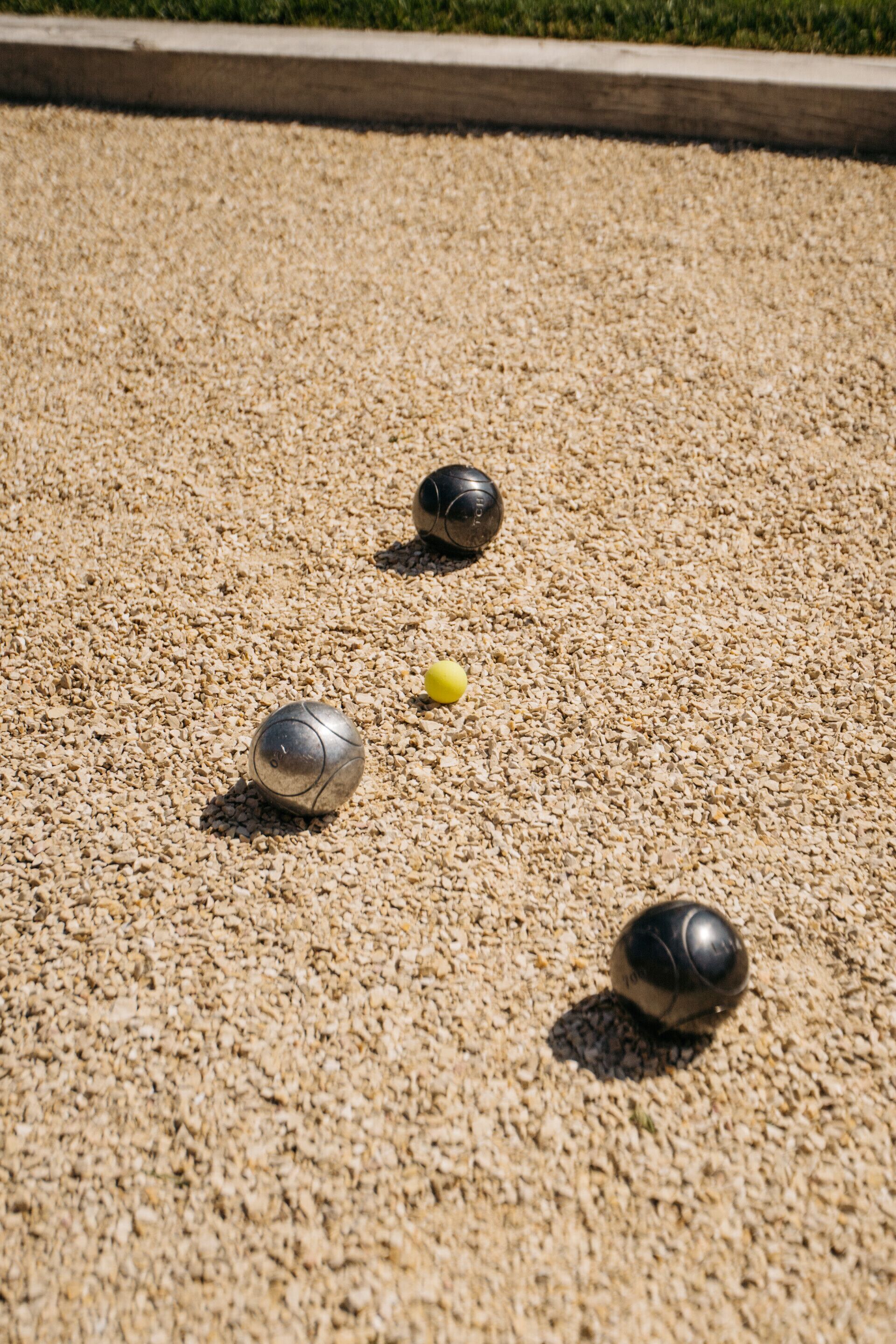 A close-up of a billiard table with three balls on a textured surface.