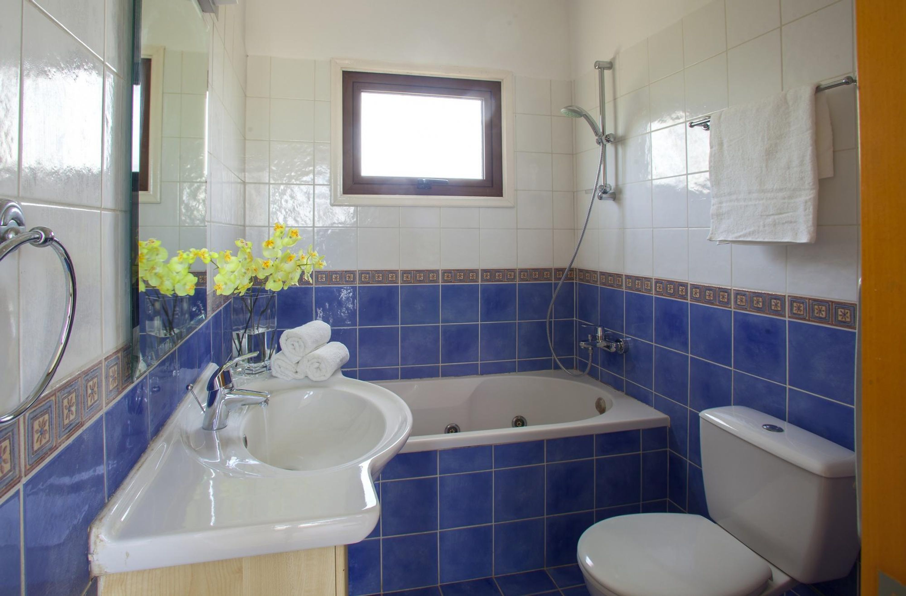 A bathroom with a bathtub, a sink, and a toilet.