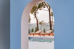 A pool area with lounge chairs and a view of trees and hills. - Luxury Almancil Villa With Heated Pool by Ideal Homes (Loulé)