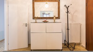 A room with a white wardrobe, a mirror with a gold frame, and a radiator. - Fresh and Clean apt for 6 in Koukaki (Athens)