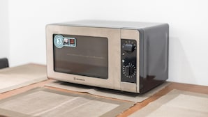 A microwave oven with a digital display, control panel, and brand name visible. - Fresh and Clean apt for 6 in Koukaki (Athens)