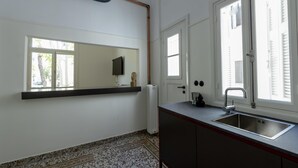 A kitchen with a built-in sink, a window, and a radiator. - An Outstanding 3 Bdrm Apartment in the Heart of Athens (Athens)