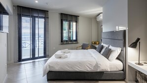 Une chambre moderne avec un grand lit, une chaise et un bureau.