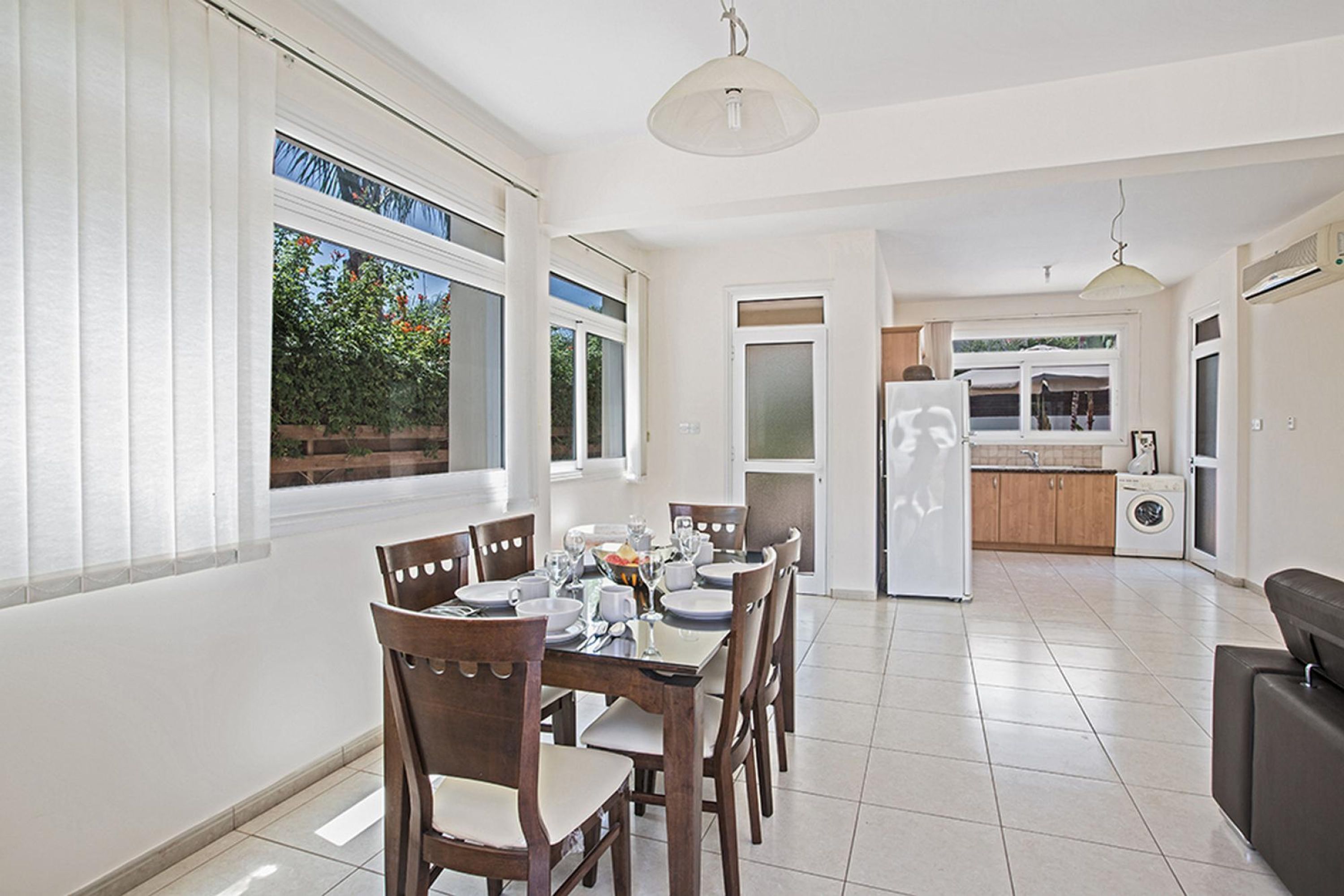 A modern kitchen with a refrigerator, oven, and sink.