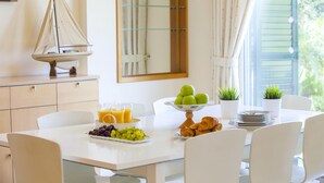 A breakfast table with fruits, croissants, and orange juice. - Protaras Coast Panorama (Paralimni)
